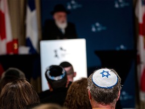 Members of Montreal's Jewish community gather for a vigil on Oct. 9, 2023.