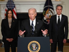 U.S. President Joe Biden speaks, backed by Vice President Kamala Harris and Secretary of State Antony Blinken.