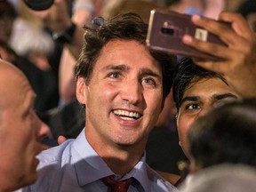 Justin Trudeau and a man take a selfie.