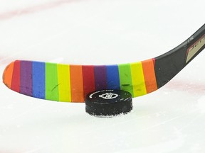 A hockey stick blade wrapped with rainbow-coloured tape.
