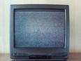 An old-fashioned TV showing static on the screen.