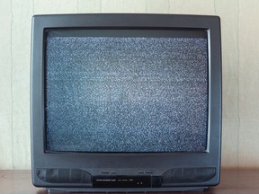 An old-fashioned TV showing static on the screen.
