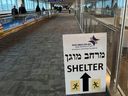 A sign informing passengers about the location of rocket shelters at Ben Gurion International Airport near Tel Aviv, Israel.