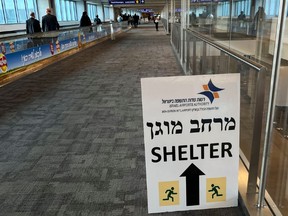 A sign informing passengers about the location of rocket shelters at Ben Gurion International Airport.