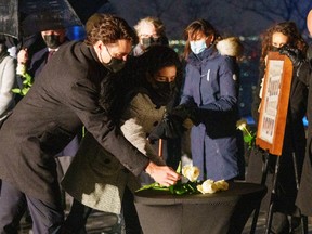 Prime Minister Justin Trudeau places a white rose for victims during a vigil in memory of the 14 victims of the 1989 Ecole Polytechnique massacre.
