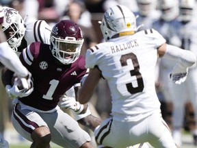 Mississippi State wide receiver Zavion Thomas (1) takes a pass upfield for a first down against Western Michigan safety Tate Hallock (3) during the second half of an NCAA college football game, Saturday, Oct. 7, 2023, in Starkville, Miss.