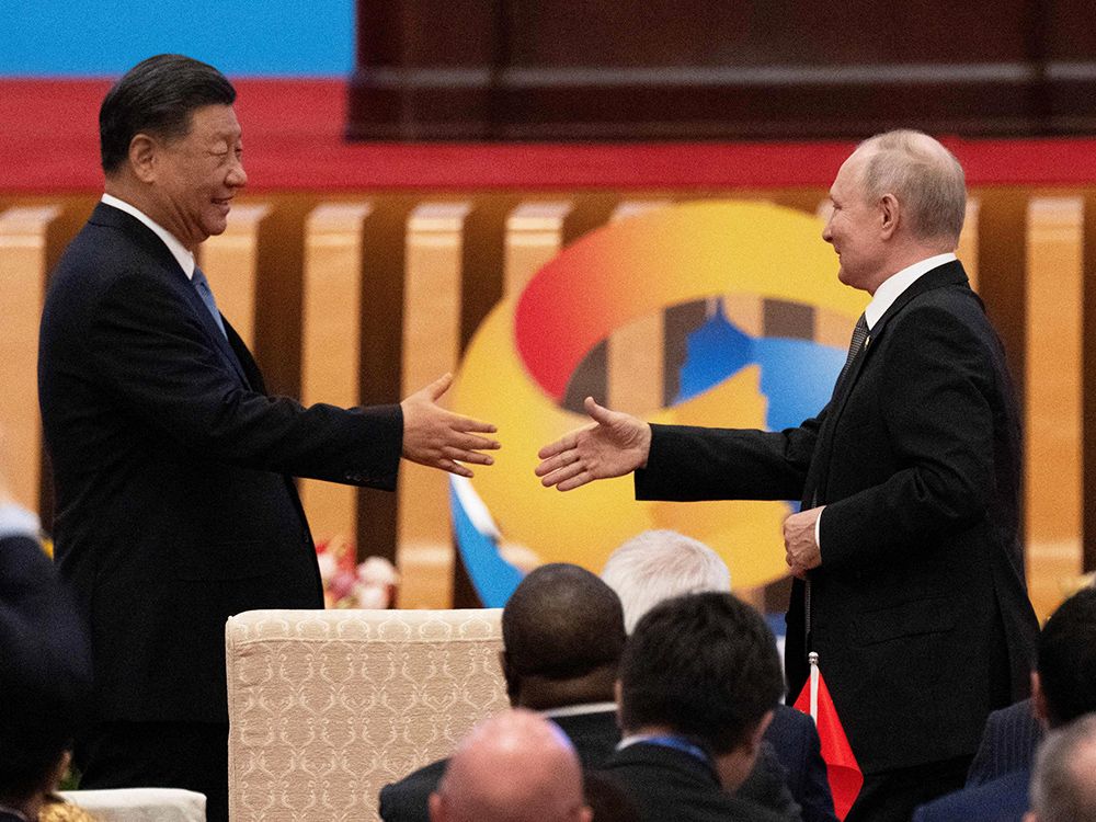 Chinese President Xi Jinping, left, shakes hands with Russian President Vladimir Putin during the opening ceremony of the Third Generation and Road Forum for International Cooperation at the Great Hall of the People in Beijing, Oct. 18, 2023.