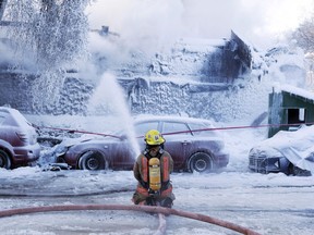A Montreal anti-racism group says it has filed a complaint with Quebec's human rights commission on behalf of two Black firefighters who say they were subject to discrimination on the job. Firefighters battle a five-alarm fire in an apartment building on a frigid winter day, in Montreal, Friday, Feb. 3, 2023.