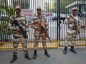 Indo-Tibetan Border Police stand guard outside the office building where Indian tax authorities raided BBC's office in New Delhi