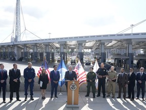 Acting commissioner of Customs and Border Protection Troy Miller, center, speaks during a news conference at the San Ysidro Port of Entry, Thursday, Oct. 26, 2023, in San Diego. The U.S. Customs and Border Protection has announced a new government-wide strategy that will target not only fentanyl but precursor materials used to make the synthetic opioid.