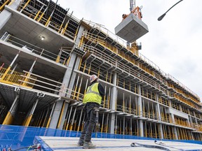 Stalled construction projects are holding up the delivery of at least 25,000 housing units across Quebec, according to a survey of 42 real estate developers conducted by a housing construction industry association. A new condo site under construction in Montreal, Friday, June 9, 2023.