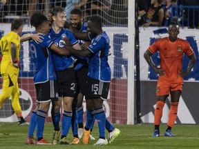 CF Montreal midfielder Lassi Lappalainen (21) is congratulated by teammates on his goal against Houston Dynamo goalkeeper Steve Clark (12) in the final seconds of play during second half MLS soccer action on Wednesday, Oct. 4, 2023 in Montreal.