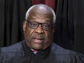 FILE - Associate Justice Clarence Thomas joins other members of the Supreme Court as they pose for a new group portrait, at the Supreme Court building in Washington, Oct. 7, 2022. All or most of a $267,000 loan obtained by Supreme Court Justice Clarence Thomas to buy a high-end motorcoach appears to have been forgiven, raising tax and ethics questions, according to a new report by Senate Democrats.