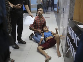 Palestinian children wounded in Israel strikes are brought to Shifa Hospital in Gaza City on Wednesday, Oct. 11, 2023.
