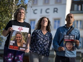 Relatives of Israelis missing or held hostage by Hamas — (from left) Michal Dorset showing a picture of her niece Romi Gonen, Doris Liber representing her son Guy Iluz and Assaf Shem Tov showing a picture of his nephew Omer Shem Tov — pose after a meeting at the International Committee of the Red Cross headquarters in Geneva on Oct. 20, 2023.