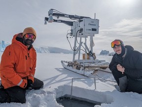 A Calgary researcher in Antarctica researching sea ice says he's seen first hand just how big an impact climate change has had in the region. Vishnu Nandan, left, a post-doctoral associate with the University of Calgary, and Robbie Mallett, from the University of Manitoba, are seen using state-of-the-art ground-based radar system to improve how radar satellites measure the thickness of Antarctic sea ice and snow, at Rothera Research Station, Antarctica, in an undated handout photo.
