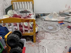 A child's bed covered in blood