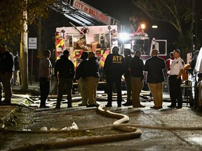 First responders work the scene after a deadly fire on Thursday, Oct. 19, 2023, in Baltimore.
