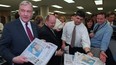 National Post founder Conrad Black hands out copies of the Post's first edition.