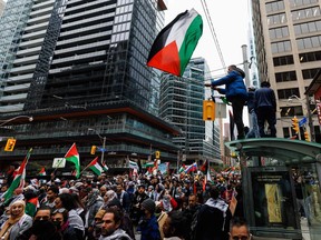 Demonstrators in support of Palestinians wave Palestinian flags during a protest in Toronto on Oct. 9, 2023.