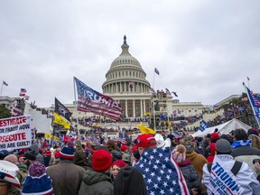 FILE - Rioters loyal to President Donald Trump at the U.S. Capitol in Washington, Jan. 6, 2021. Two Missouri men are facing federal charges accusing them of assaulting police officers during the U.S. Capitol riot, including pushing bike racks that were being used as barricades into a line of officers.