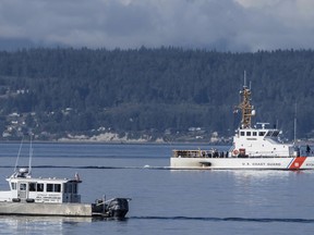 FILE - A U.S. Coast Guard boat and Kitsap, Wash., County Sheriff boat search an area, Monday, Sept. 5, 2022, near Freeland, Wash., on Whidbey Island north of Seattle where a chartered floatplane crashed the day before, killing 10 people. On Thursday, Oct. 5, 2023, the National Transportation Safety Board confirmed that a mechanical issue caused the seaplane to crash.