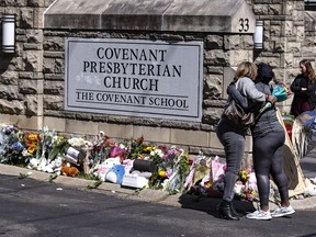 FILE - Two women hug near a memorial at the entrance to The Covenant School, March 29, 2023, in Nashville, Tenn. The Tennessee Court of Appeals heard arguments Monday, Oct. 16, on whether Tennessee law gives the parents of school shooting victims the right to have a say over which police records are released to the public.