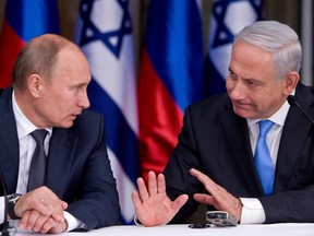 Russian President Vladimir Putin (L) listens to Israeli Prime Minister Benjamin Netanyahu as they prepare to deliver joint statements after their meeting and a lunch in the Israeli leader's Jerusalem residence on June 25, 2012 in Jerusalem, Israel.