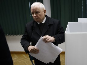 Poland's conservative ruling Law and Justice party leader Jaroslaw Kaczynski prepares to vote during parliamentary elections in Warsaw, Poland, Sunday, Oct. 15, 2023. Poland is holding a high-stakes election on Sunday that has energized many voters, with the ruling conservative nationalist party pitted against opposition groups that accuse it of eroding the foundations of the democratic system.