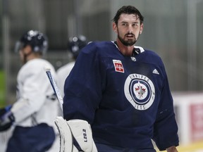 Winnipeg Jets goaltender Connor Hellebuyck looks on during opening day of their NHL training camp in Winnipeg, Thursday, Sept. 21, 2023. If an NHL team's success begins from the net out, the smile on the face of Jets head coach Rick Bowness reinforced his confidence in the team's goaltenders.THE CANADIAN PRESS/John Woods