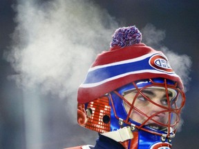 Steam rises from Montreal Canadiens goalie Jose Theodore during the second period of NHL outdoor action against the Edmonton Oilers at Commonwealth Stadium in Edmonton on Saturday Nov. 22, 2003.
