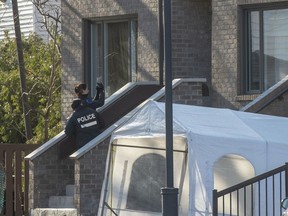 Police investigate the scene where a woman and two children were found dead in a home, Wednesday, December 11, 2019 in Montreal.THE CANADIAN PRESS/Ryan Remiorz