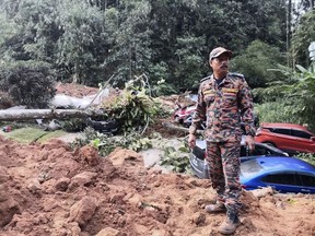 FILE - This photo released by Korporat JBPM, a rescue worker in an operation following a landslide at a campsite in Batang Kali, Selangor state, on the outskirts of Kuala Lumpur, Malaysia, Dec. 16, 2022. A landslide that killed 31 people at an unlicensed campground in 2022 was caused by persistent heavy rainfall, not human activity, a Malaysian government investigation concluded. (Korporat JBPM via AP, File)