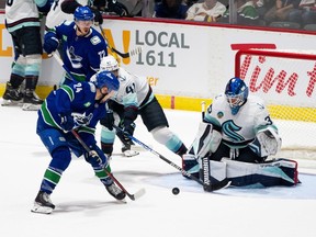 Vancouver Canucks' Pius Suter (24) takes a shot on Seattle Kraken goaltender Joey Daccord (35) during the second period of preseason NHL action in Abbotsford, B.C. on Wednesday, Oct. 4, 2023.