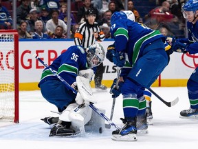 Vancouver Canucks goaltender Thatcher Demko (35) stops St. Louis Blues Brayden Schenn's (10), not seen, shot as Vancouver's Filip Hronek (17) defends during the second period of an NHL hockey game in Vancouver, B.C., Friday, Oct. 27, 2023.