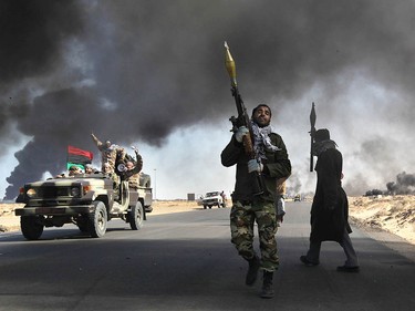 In March 2011, Libyan rebels battle government troops loyal to Moammar Gadhafi in Ras Lanuf, a strategic oil town.