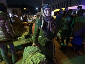 An ethnic Armenian woman from Nagorno-Karabakh carries her suitcase to a tent camp after arriving to Armenia's Goris in Syunik region, Armenia, late Friday, Sept. 29, 2023. Armenian officials say that by Friday evening over 97,700 people had left Nagorno-Karabakh. The region's population was around 120,000 before the exodus began.