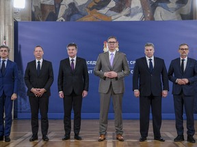 In this photo provided by the Serbian Presidential Press Service, Serbian President Aleksandar Vucic, third right, poses with Italian diplomat Alessandro Cattaneo, left, French President's Advisor Emmanuel Bonne, second left, European Union envoy Miroslav Lajcak, third left, US Deputy Assistant Secretary Gabriel Escobar , second right, and German Chancellor's Advisor Jens Plettner, right, in Belgrade, Serbia, Saturday, Oct. 21, 2023. The envoys of the European Union and the United States urged on Saturday Kosovo and Serbia to resume dialogue as the only way to de-escalate the soaring tension between the two nations. This is the first such visit since Sept. 24 when around 30 Serb gunmen crossed into northern Kosovo, killing a police officer and setting up barricades, before launching an hours-long gun battle with Kosovo police. (Serbian Presidential Press Service via AP)