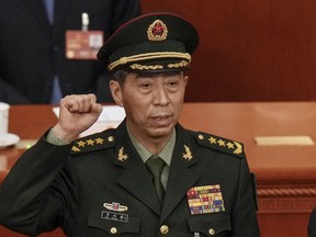 FILE - Newly elected Chinese Defense Minister Gen. Li Shangfu takes his oath during a session of China's National People's Congress (NPC) at the Great Hall of the People in Beijing on March 12, 2023. China has replaced Defense Minister Gen. Li, who has been out of public view for almost two months with little explanation, state media reported Tuesday, Oct. 24.
