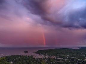 FILE - A rainstorm moves over the Atlantic Ocean after passing through Camden, Maine, at sunset Aug. 1, 2023. Environmental groups on Wednesday Oct. 25, 2025 urged a moratorium on deep sea mining ahead of an international meeting in Jamaica where a U.N. body will debate the issue.
