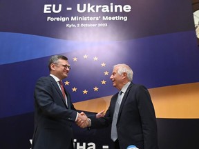 In this photo distributed by Dmytro Kuleba Twitter on Monday, Oct. 2, 2023, Ukrainian Foreign Minister Dmytro Kuleba, left, and EU High Representative for Foreign Affairs Josep Borrell shake hands at the opening of the informal EU Foreign Ministers meeting in Kyiv, Ukraine. Some of Europe's top diplomats have gathered in Kyiv in a display of support for Ukraine's fight against Russia's invasion as signs emerge of political strain in Europe and the United States about the war. (Dmytro Kuleba Twitter account via AP)