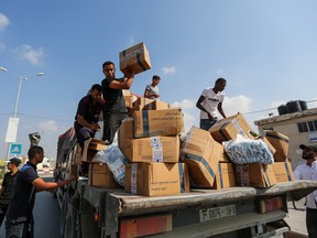 Trucks carrying aid enter Gaza through the Rafah crossing