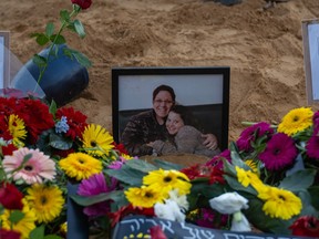 Flowers lie next to a picture during a funeral and farewell-ceremony for Liel and Ila