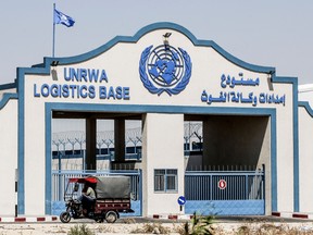 A Palestinian man rides a vehicle in front of the logistics base of the United Nations Relief and Works Agency (UNRWA) in Rafah, in the southern Gaza Strip on July 30, 2019.