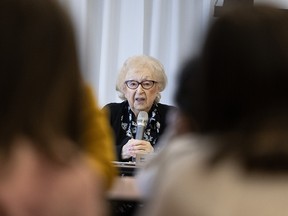 Holocaust survivor Muguette Myers speaks to school children.