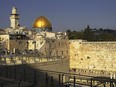 Jews pray at the Western Wall, beside the Temple Mount.