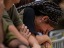 A woman cries during the funeral of Israeli Col. Roi Levy at the Mount Herzl cemetery in Jerusalem on Monday, Oct. 9, 2023. Col. Roi Levy was killed after Hamas militants stormed from the blockaded Gaza Strip into nearby Israeli towns. (AP Photo/Maya Alleruzzo)