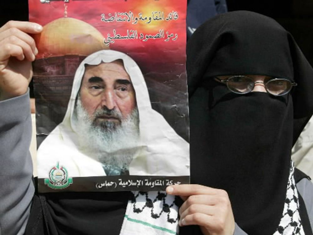  A Palestinian Hamas supporter holds a portrait of Sheikh Ahmed Yassin during a demonstration at the Burj el-Barajneh Palestinian refugee camp in Beirut in 2004.