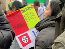 A woman at a pro-Palestinian protest in Toronto holds a sign comparing Israel to Nazi Germany. 