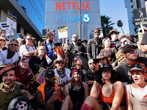 SAG-AFTRA members pose for a group photo, during a 'Post Apocalyptic' themed picket.